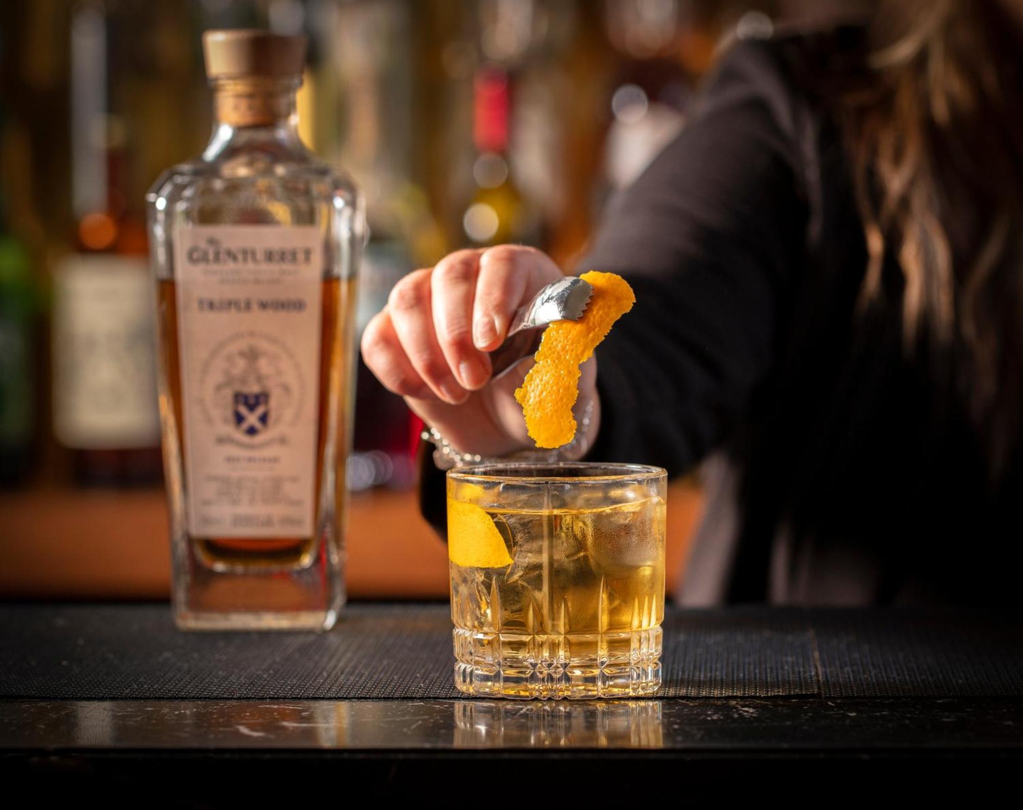 Schloss Roxburghe, Part Of Destination By Hyatt Zewnętrze zdjęcie A bartender adding a lemon twist to a glass of GINfinity